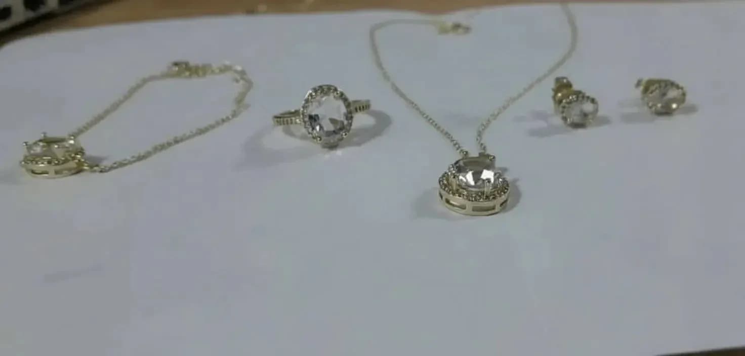 Jewelry set including transparent stone rings, necklaces, earrings, and a hand lace.