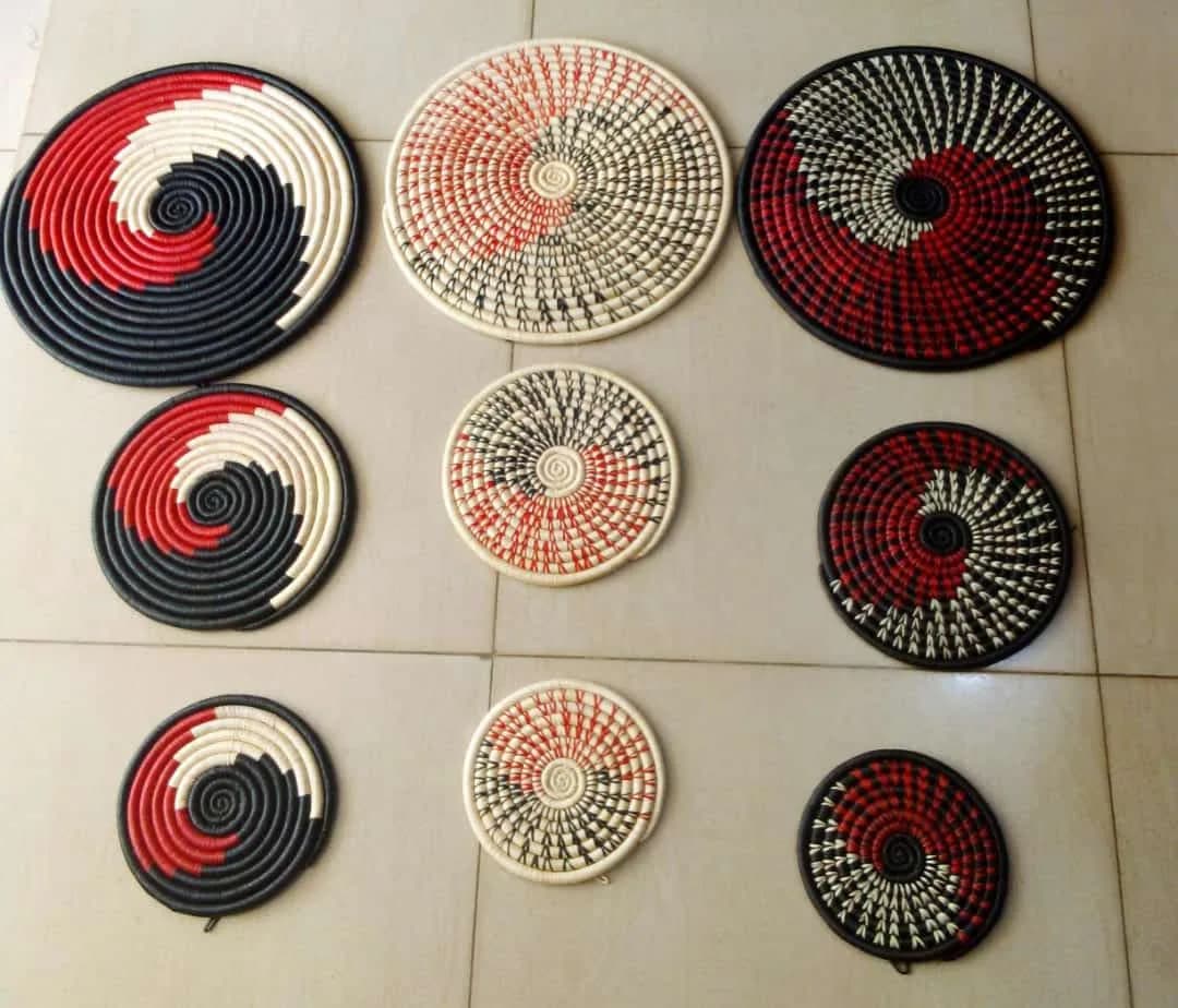 A SET OF THREE WALL HANGING HAND WOVEEN BASKETS